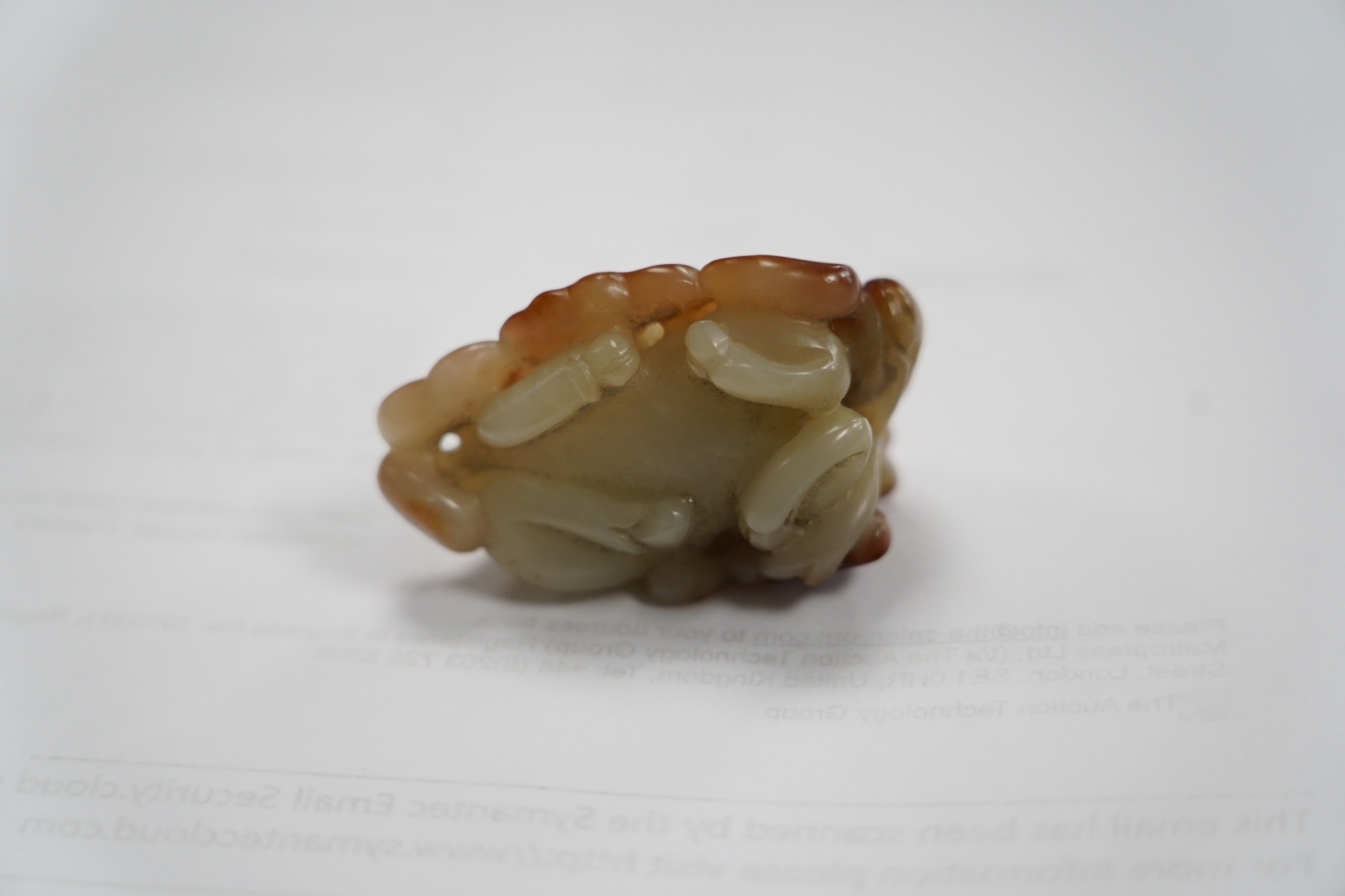 A Chinese pale celadon and russet skin jade figure of a stag, 19th century